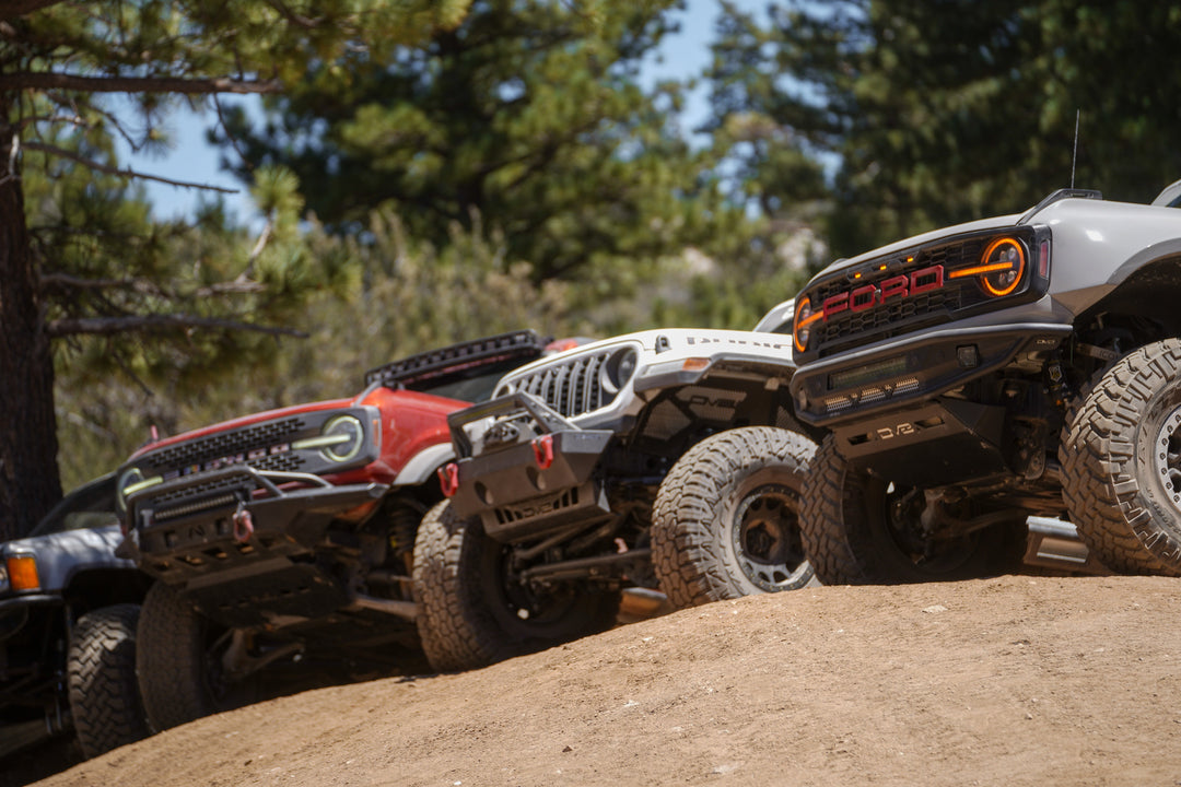 DV8's off-road bumpers mounted to a Bronco, Jeep, and Raptor.